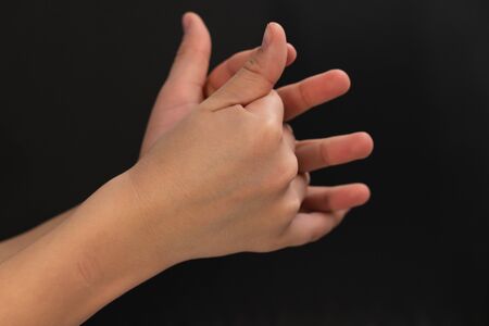the palm of a teenager's hand on a black background. body partsの写真素材