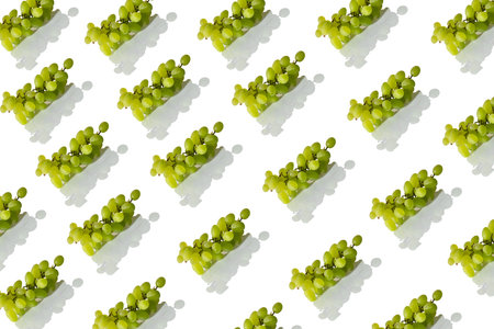 pattern fresh green grapes on an isolated white background with reflection