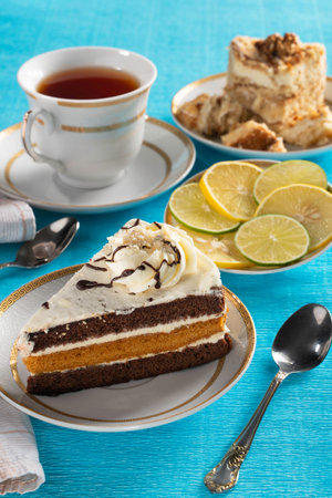 still life a piece of sponge cake on a white plate with a Cup of tea
