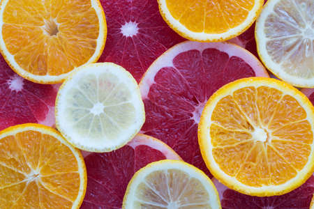 orange lemon grapefruit slices as background top view close upの写真素材