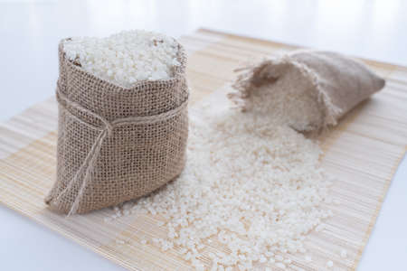 grits white rice in a linen bag on the table close up, foodの写真素材