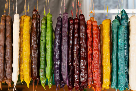 Multicolored delicious fresh Georgian Sweets snack. Churchkhela hanging in the market.