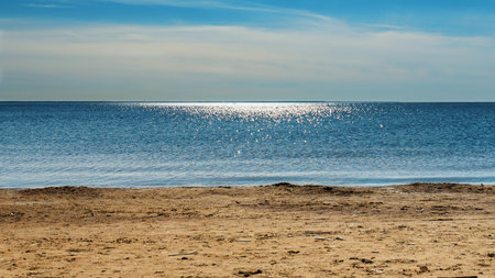panorama seascape yellow warm sand, blue sea and sky