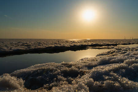 winter landscape sunset over the ice-covered Gulf of Finlandの写真素材