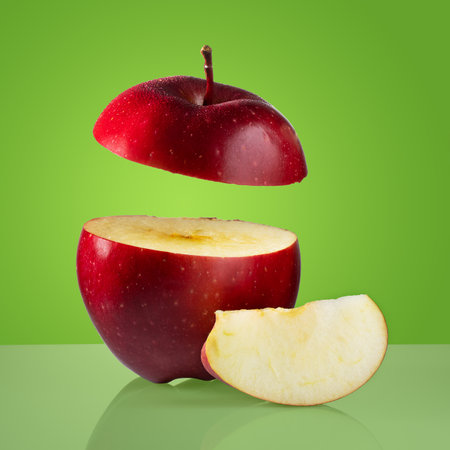 fresh ripe red apple on a green backgroundの写真素材