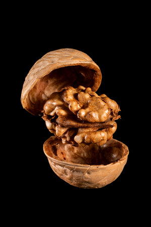 one walnut on a black isolated background close-up