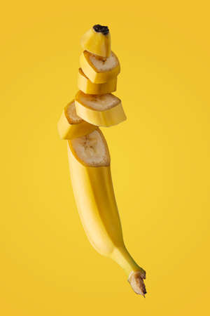 sweet ripe fresh banana on a yellow backgroundの写真素材
