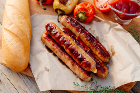 Oktoberfest. Grilled pork sausages with fried sweet pepper and French loafの写真素材