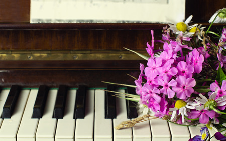 bouquet of summer flowers: the garden and field lies on a piano.の写真素材