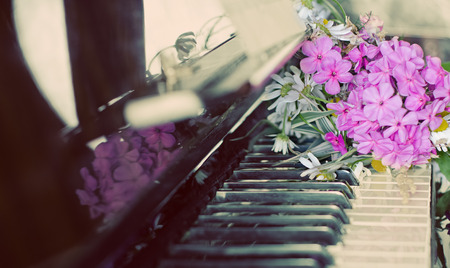bouquet of summer flowers: the garden and field lies on a piano.の写真素材