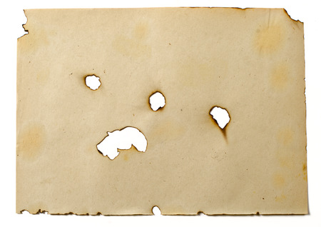 the sheet of old burned paper on the isolated white backgroundの写真素材