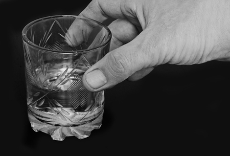 black-and-white image of male hands with a glass of water.
の写真素材