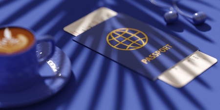 Flat lay of traveler's accessories, Essential vacation items, headphones, passport, ticket, coffee. Shadow of palm tree. Travel planning concept blue background with copyspace.の写真素材