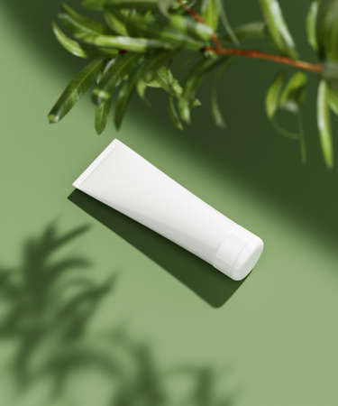 Monocolor scene for cosmetic product presentation. Cosmetic jar and green leaf on color background. 3d render.の写真素材