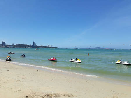 Scooters parked in the sea white beach, clear sky. Pattaya city.の写真素材