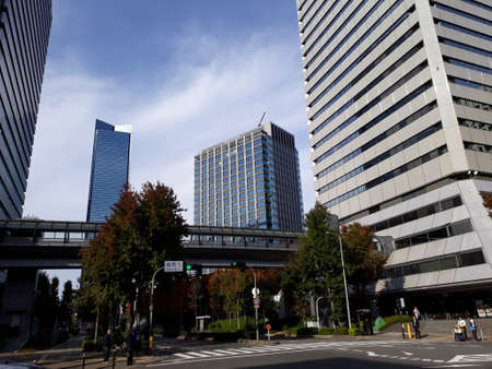 The business district in Osaka with many skyscrapers. In the picture, there is a junction and a crosswalk for people to cross.の写真素材