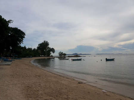 Boats moored on a calm beach.の写真素材
