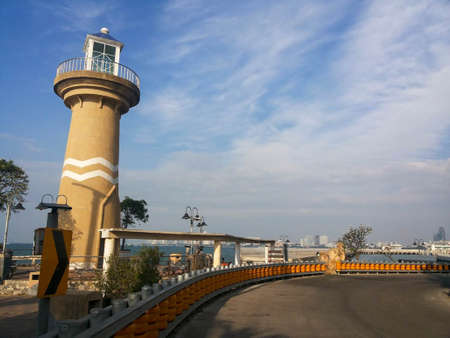 road and lighthouse by the seaの写真素材