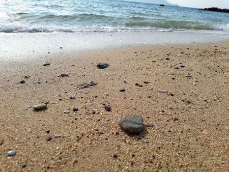 rocks on the beach with grains of sandの写真素材