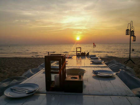 Dinner by the sea at sunsetの写真素材