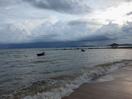 The beach where the rain is falling on the seaの写真素材