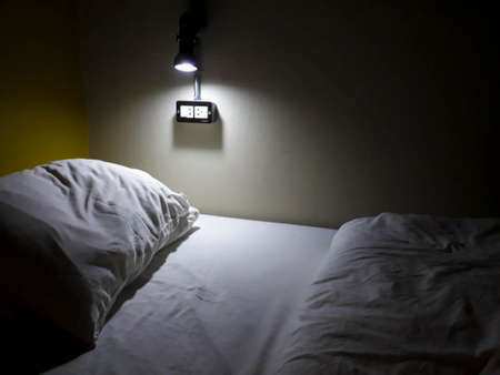 dim light on the bedの写真素材