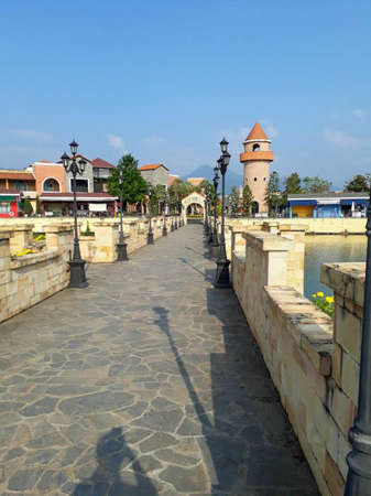 Bridge over a canal made of stone. There are lamp posts on the bridge as well.の写真素材