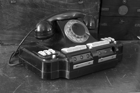 Old scratched phone with various buttons
and  keys with a large disk and  tube of ebonite.Shot in the style of analog black and white photographyの写真素材