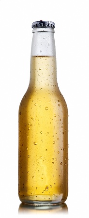 Non-glossy white beer bottle, back lighted showing a glowing golden beer content, drops and condensationの写真素材