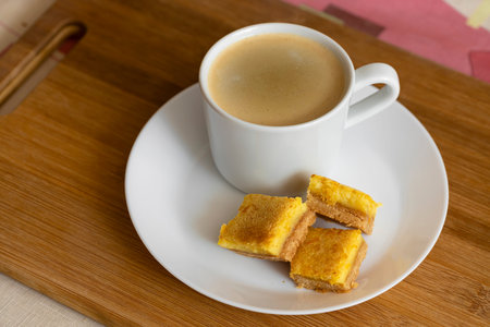 A cup of espresso coffee and orange cookies are on the table. Food photo.の写真素材