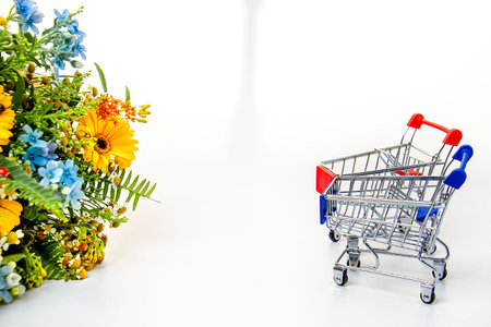 A beautiful bouquet of flowers and two carts from the supermarket. Place for an inscription.