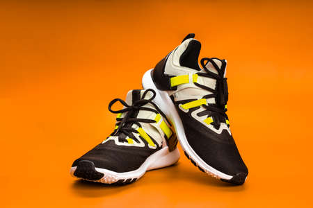 New running or unbranded running shoes on orange background. Men's sports shoes. A pair of sports shoes.の写真素材