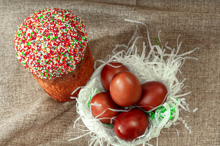 Easter cake and red eggs on a rustic table. Easter background.