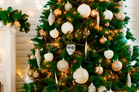 Photo of luxury gift boxes under the tree, Christmas decorations for the home, beautiful Santa gift wrapping, fireplace, holiday tree decorated with garland, baubles, traditional holiday. Christmas.の素材