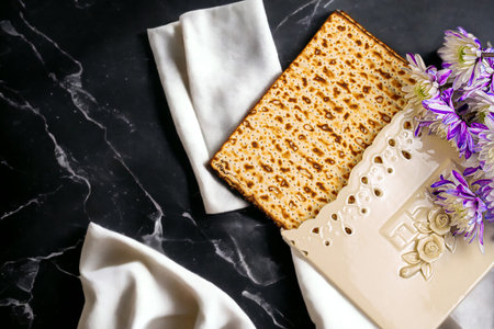 Passover background with matzah and white and purple gerberas. Jewish holiday. View from above....