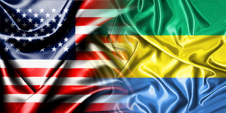 The national flags of the United States and Gabon are combined into one and placed side by side on a...