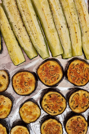 Roasted eggplant and zucchini on a baking sheet. Top view.の写真素材