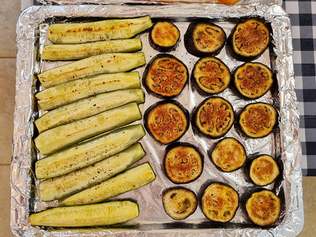 Roasted eggplant and zucchini on a baking sheet. Top view.の写真素材