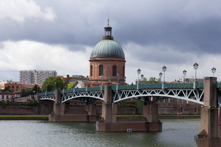 View to Hospital La Grave from Pont Saint Pierre on a cloudy dayの写真素材