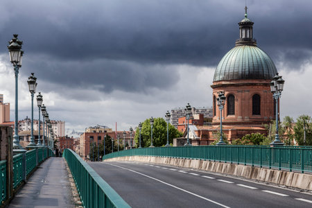 View to Hospital La Grave from Pont Saint Pierre on a cloudy dayの写真素材