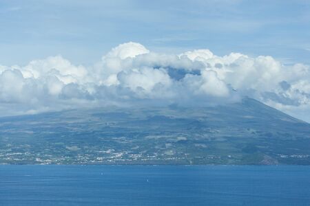 Mountain of PIco with clouds forming around its peak, a view from Faial, Azores, Portugalの写真素材