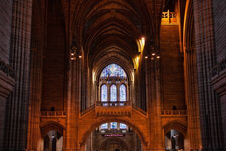 Liverpool, UK - 19 October 2019: Interior of Cathedral Church of Christ showing a stained glass window and naveのeditorial素材