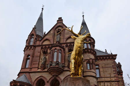Konigswinter, Germany - 2 March 2019: Drachenburg castle on a gloomy day with a statue of golden deerのeditorial素材
