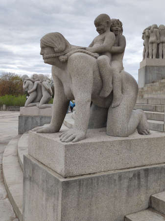 Oslo, Norway - 30 April 2022: Mother with her children on her back in Frogner Parkのeditorial素材