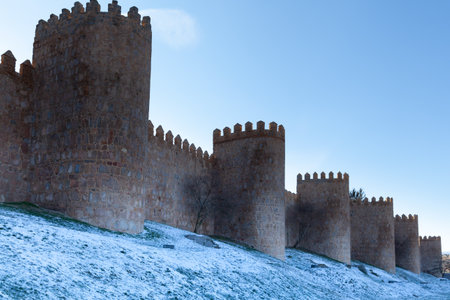 Avila, Spain - 6 January 2021: Medieval wall of Avila covered with snowのeditorial素材