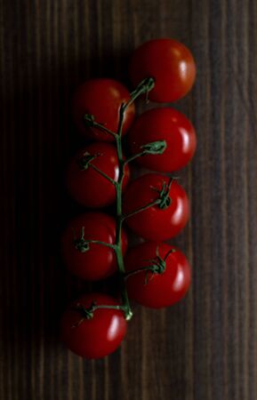 Tomatoes on wooden background. Top viewの写真素材