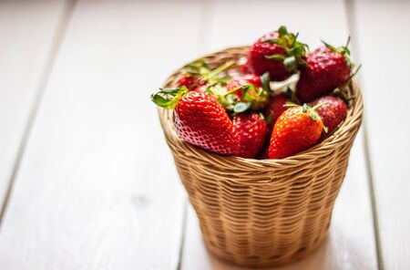 Strawberries in a bowl on a wooden background. Healthy eatingの写真素材