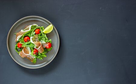 Salad with arugula, tomatoes and prosciutto. Italian cuisine. Healthy eating. Dietの写真素材
