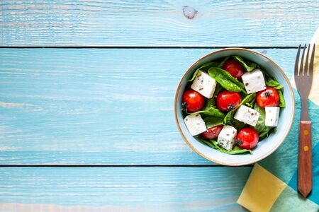 Salad with tomatoes, spinach and cheese. Italian cuisine. Healthy eating. Dietの写真素材