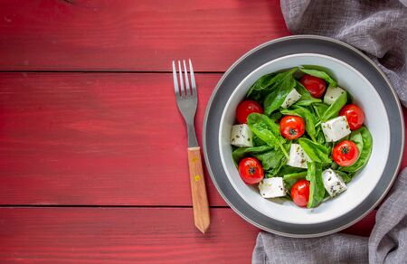 Salad with tomatoes, spinach and cheese. Italian cuisine. Healthy eating. Dietの写真素材
